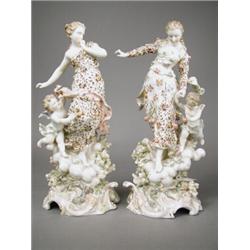 A pair of 19th century Volkstedt porcelain figurines, modelled as females and cupids amongst r...