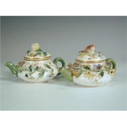 Two Minton miniature teapots with sprig foliage work, 5cm Est. 200/250...