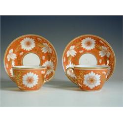 A pair of early 19th century Spode cups and saucers in orange and gilt, painted pattern No. 10...