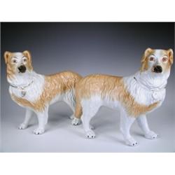 A pair of 19th century Staffordshire dogs, each with a gilt collar and lock (rubbed) (the righ...