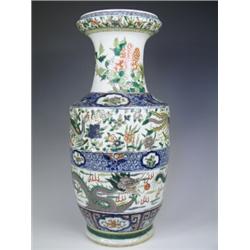 A late 19th century Chinese Famille Verte vase decorated throughout with dragons, flaming pear...