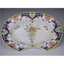 A 19th century tin glazed continental pottery polychrome barbers shaving bowl, printed and imp...