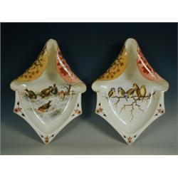 A pair of pottery wall plaques painted with birds Est. 150/200...