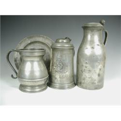 A lidded pewter tankard with a crest, a lidded jug, a quart tankard and a dish, various touch...