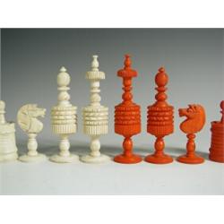 A carved bone chess set, natural and stained red, with an instruction booklet by J & R Maxwell...