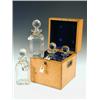 Image 1 : A mid 19th century oak tantalus box with four decanters (one matched, one damaged), in a velve...