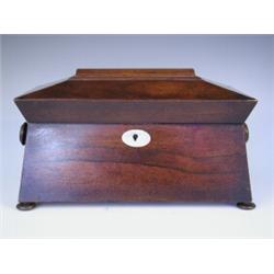 An early 19th century rosewood veneered sarcophagus shaped tea caddy with a fitted interior on...