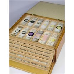 A Victorian/Edwardian pine fall front microscope slide box with twelve trays each containing t...