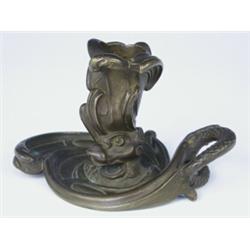 A late 19th century French bronze Rococo style chamberstick, with a mythical serpent coiled ar...