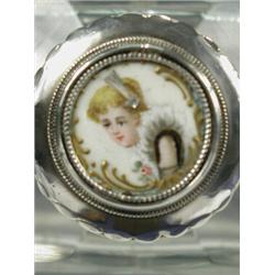 A cut glass scent bottle, the screw lid with silver and ivory mounts and an enamelled portrait...