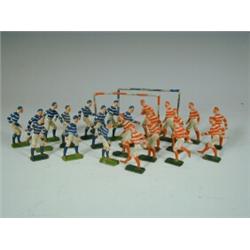 A set of late 19th century/20th century lead footballers in red/white and blue/white jerseys,...
