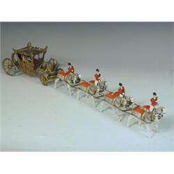 A George IV coronation coach with eight horses and four postillion riders Est. 100/150...
