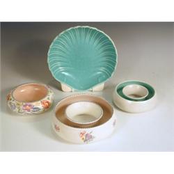 Four Poole pottery items: a shell dish, a bowl (No. 221) and two circular 'Doughnut' vases No....