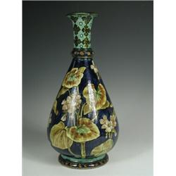 A Doulton Lambeth 'Faience' vase, painted with flowers, base with circular impressed mark 'W'...