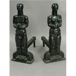 A pair of 1920's cast iron figural fire dogs, formed as naked male and female figures, 51cm hi...