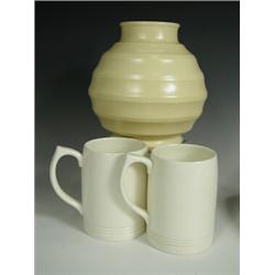 A Wedgwood Keith Murray ribbed vase, impressed marks, 18cm, together with two cream tankards,...