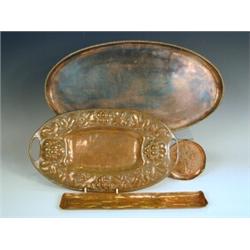 A Newlyn copper tray with fish decoration, an oval copper tray with a rope twist border by Hug...
