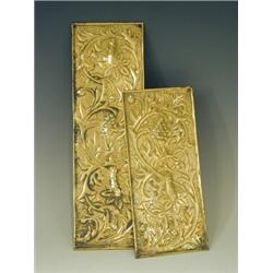 Two Keswick School brass finger plates with repousse and hammered foliage, each with monogram,...