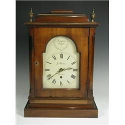A George III style mantel clock, with a mahogany case, with an arched painted dial inscribed J...