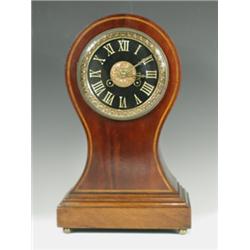 An Edwardian mahogany balloon shaped mantel clock, with inlaid chequer banding, a black slate...