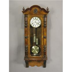A large walnut cased Vienna wall clock with Roman numerals and subsidiary seconds dial with sp...