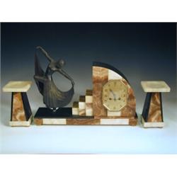 An Art Deco clock garniture with a Spelter figure, and different coloured onyx and marble, 35c...