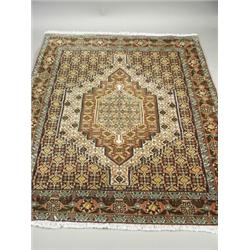 A modern beige ground handmade woollen Persian Senneh rug, 1.52 x 1.17m Est. 220/260...