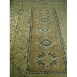 An Afghan light ground rug with geometric motifs and tasselled ends, 193 x 289cm Est. 200/2...