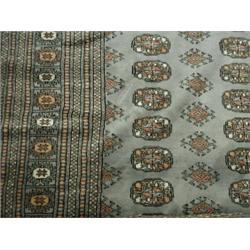 A Pakistani Bohkara rug of blue/grey ground, 187 x 260 Est. 120/150...
