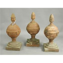 Three terracotta ball and spire finials, 73cm high Est. 300/500...