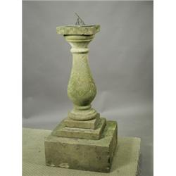 A stone sundial with a tapering column base on a stepped squant plinth, with a later sundial,...