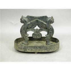 A 19th century cast iron boot scraper, in the form of two winged beasts, 27cm Est. 150/200...