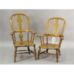 Two 19th century similar Windsor armchairs, each with pierced splat backs on shaped shaped sea...