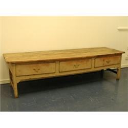 A 19th century elm and pine dresser base with a massive plank top over three drawers, 2.95m lo...