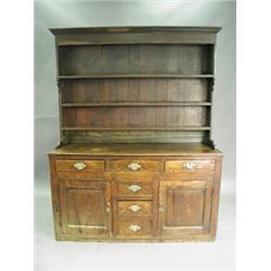 An antique oak dresser with a closed plate rack over six drawers and two panelled doors, 1.5m...