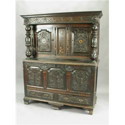 An 18th century and later dresser, the base being a Welsh carved and inlaid oak coffer with tu...