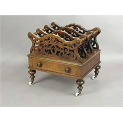 A Victorian rosewood Canterbury, with three pierced sections above a single drawer, on turned...