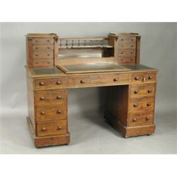 A Victorian mahogany pedestal writing desk, the raised super structure with an arrangement of...