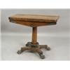 Image 1 : A late Regency rosewood fold over card table with a circular baize lining on a tapering column...