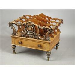 A Victorian walnut Canterbury with four shaped divisions a base drawer and turned legs, 50cm w...