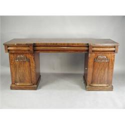 A William IV mahogany pedestal sideboard, with three cushion drawers below an inverted front,...