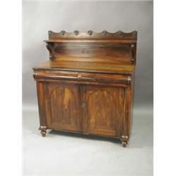 A William IV rosewood chiffonier with a shaped back and single tier, two cushion frieze drawer...