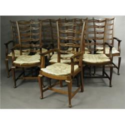 A set of eight Anglo-Indian hardwood dining chairs with pierced ladder backs, each with swept...