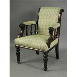 An early Victorian mahogany library chair, with lion mask terminals to the arms, on turned tap...