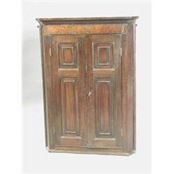 A George III mahogany corner cupboard, with a burr elm frieze above two panelled doors, 108cm...