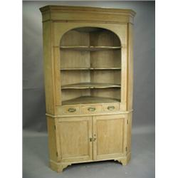 A Georgian style mahogany corner cupboard, with a pair of astragal glazed doors over solid pan...