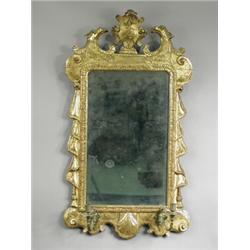 A George II style carved wood and gilt girandole, the bevel edged rectangular glass with an or...