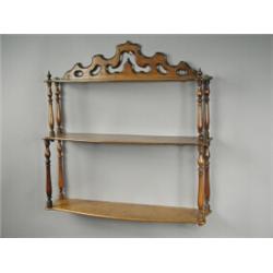 A 19th century mahogany three tier hanging shelf with bow front shelves and turned columns, 65...