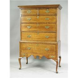 An 18th century oak chest the low stand with inlaid stringing, and cabriole legs, 101cm wide x...