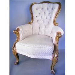 A Victorian easy chair with a foliate carved walnut show frame on scrolling legs, (re-upholste...